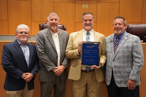 The City of Cape Coral accepts the Water Conservation Award from the Florida Irrigation Society.  Left to right: Scott King, Florida Irrigation Society, Michael Ilczyszyn, Cape Coral City Manager, Jeff Pearson, Cape Coral Utilities Director, Bill Steinke, Cape Coral Mayor Pro Tem